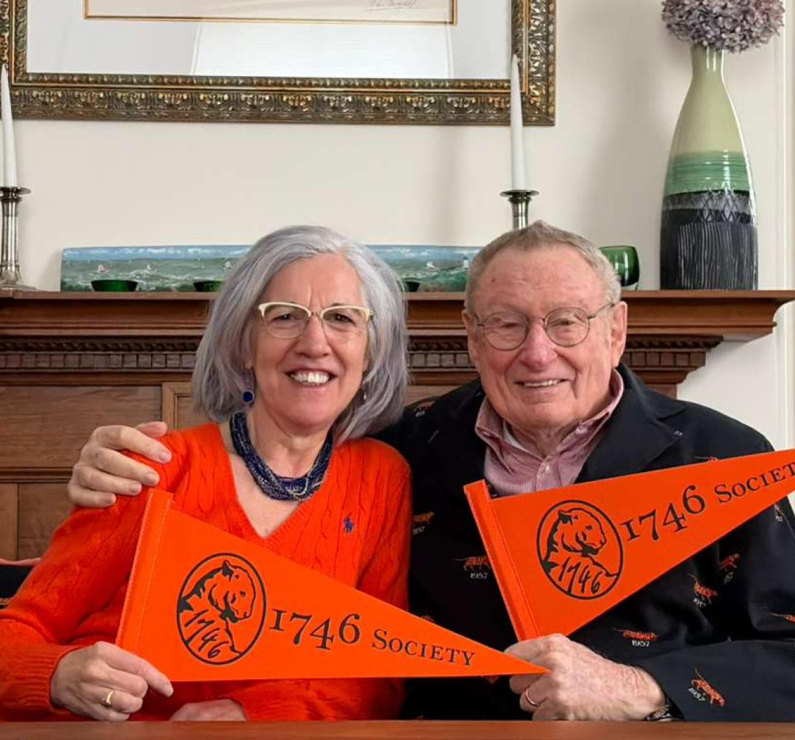 Ada and Tom Deuel hold 1746 Society pennants