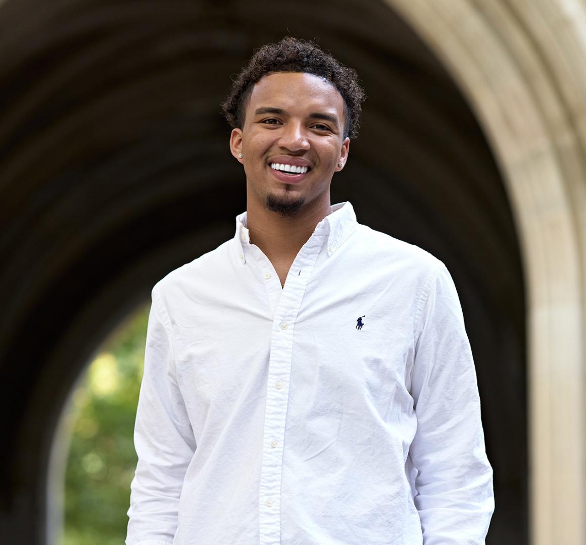 D'Schon Simmons smiling in front of Princeton campus arch.