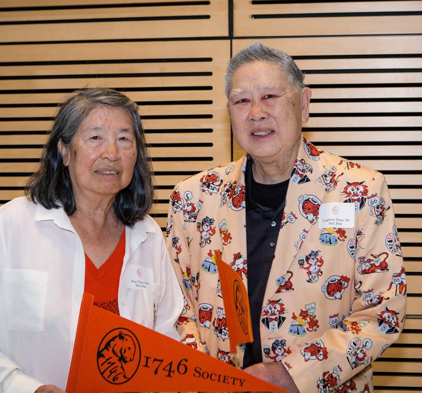 Kay and Leighton Chen, holding an orange Princeton pennant