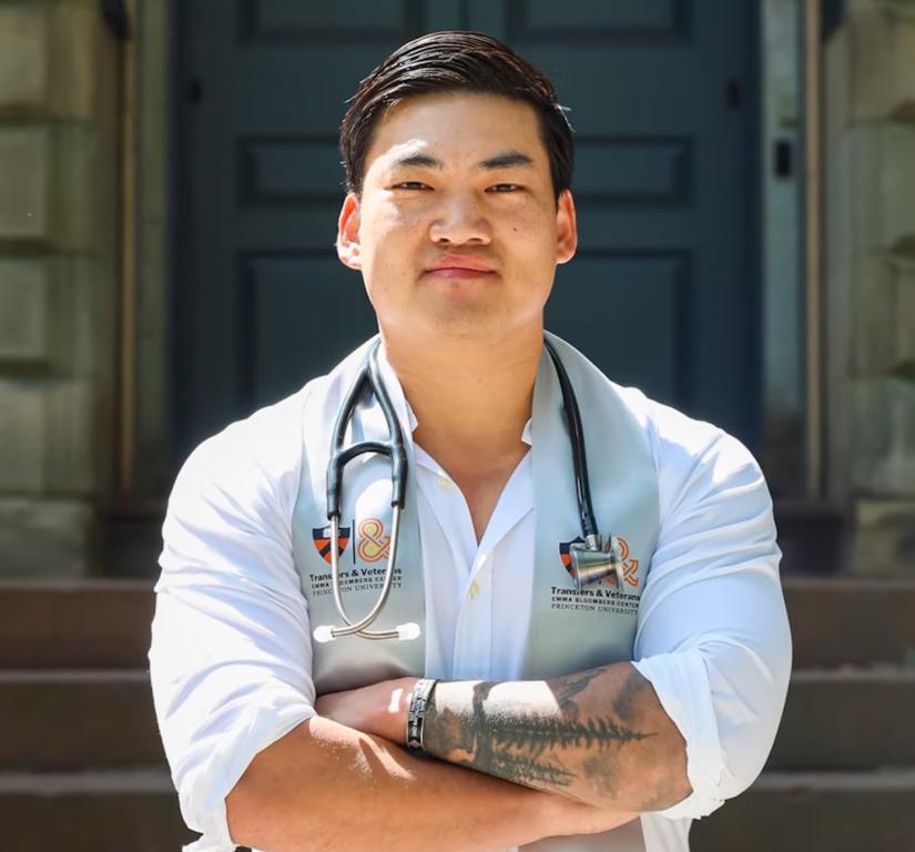 Luke Hixon, standing in front of Nassau Hall with a stethoscope handing around his neck
