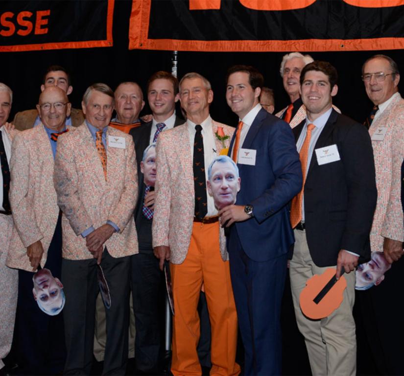 Chase Bryce, surrounded by alumni holding cut-outs of his face