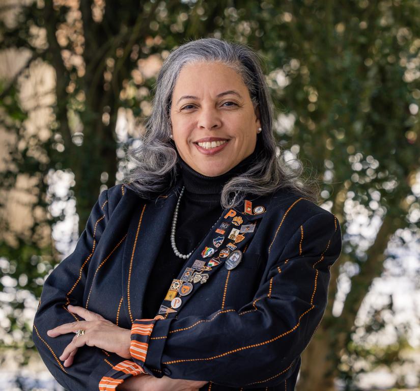 Patrice Jean, arms crossed, dressed in her orange-striped black Princeton blazer.