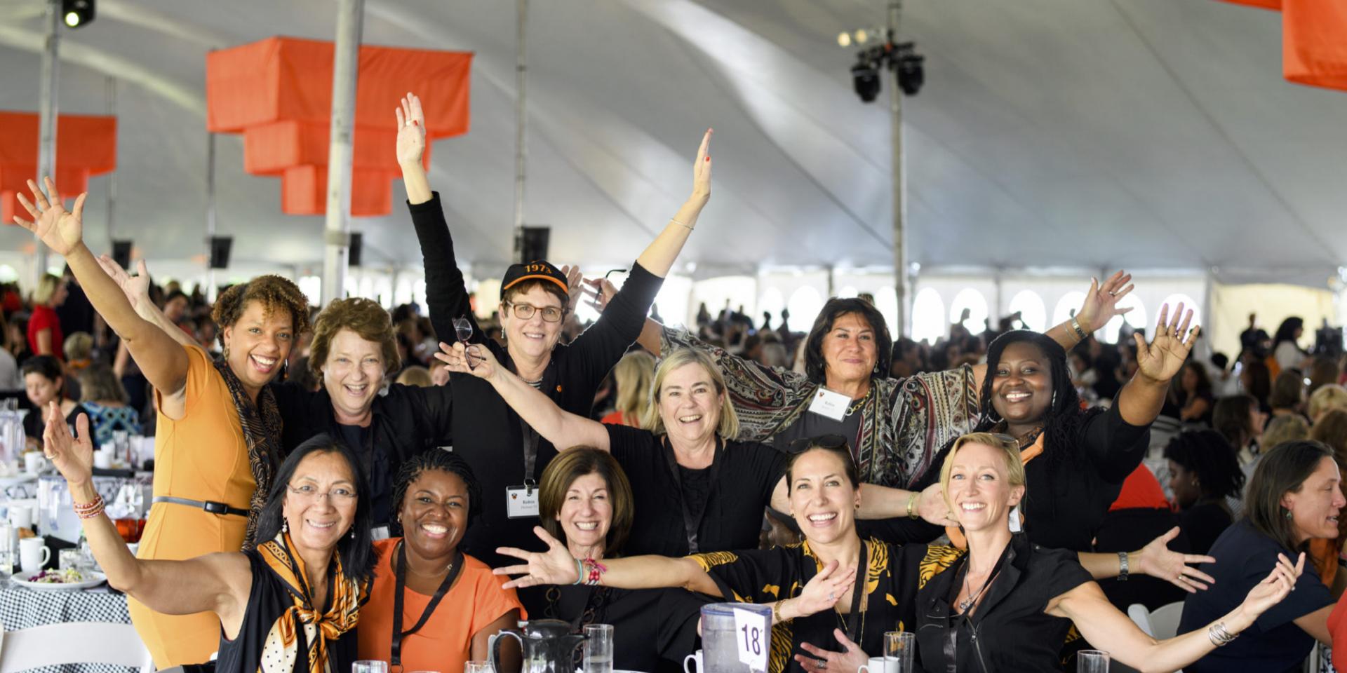 Women at table under tent during She Roars conference