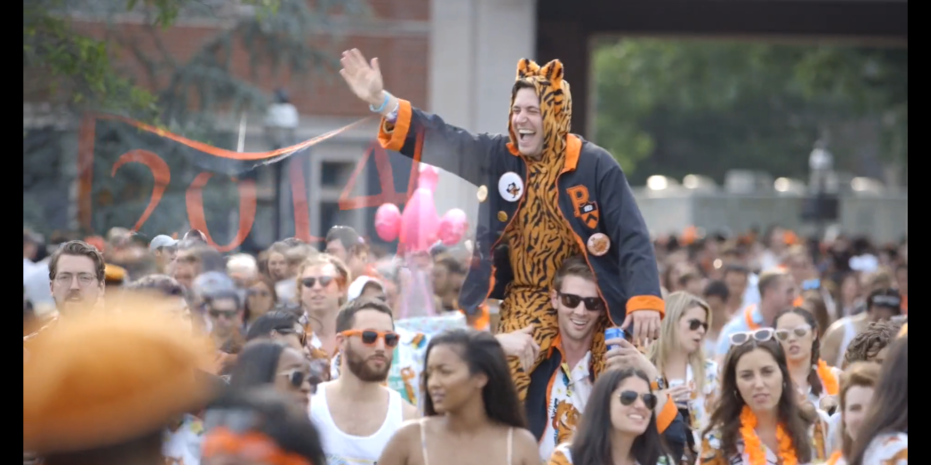 P-rade group shot with tiger costume-wearing alum in center.