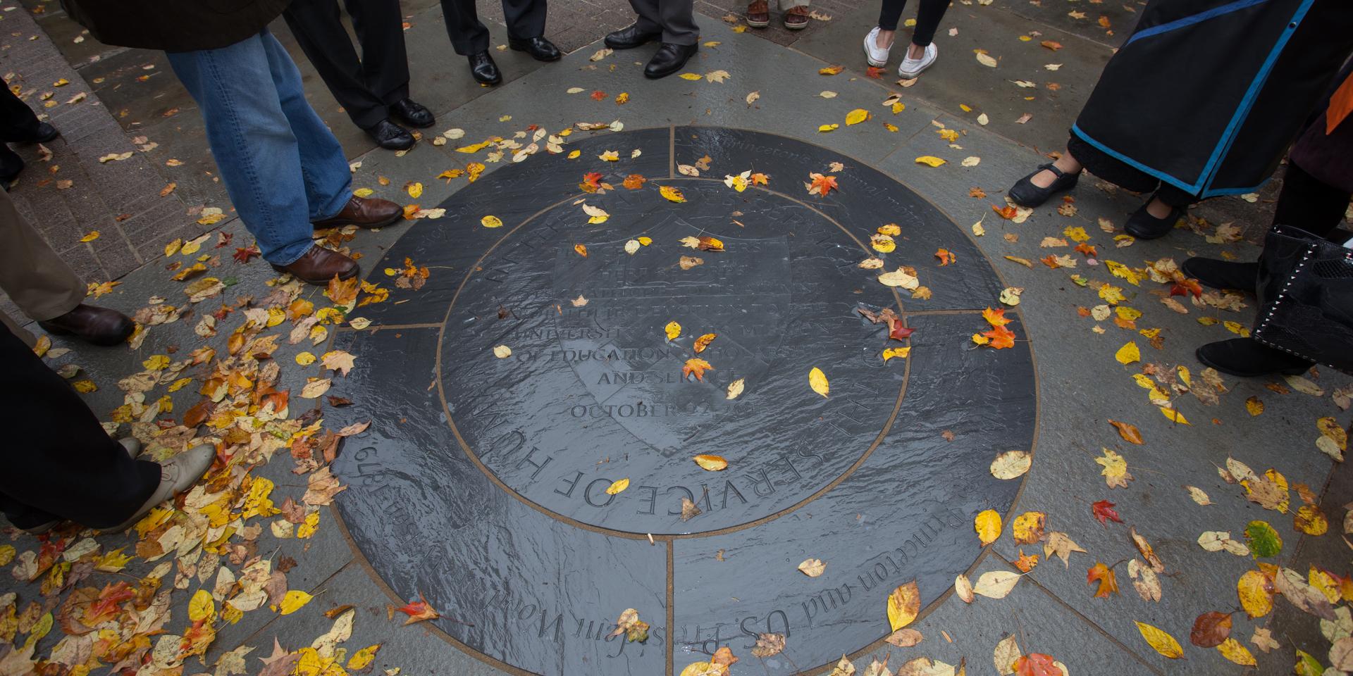 Service to Humanity medallion with autumn leaves