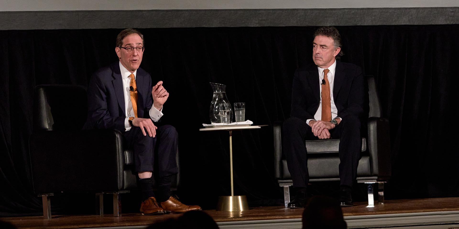 President Christopher Eisgruber on stage, speaking with Wyc Grousbeck
