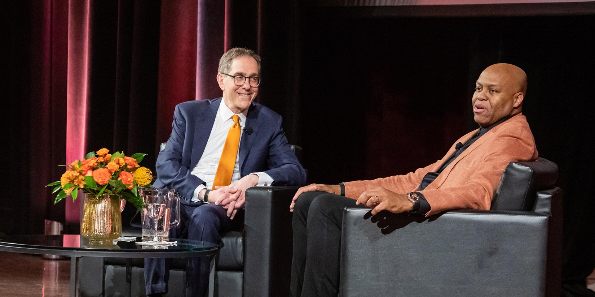 President Eisgruber smiling at Craig Robinson during a Venture Forward event in Chicago