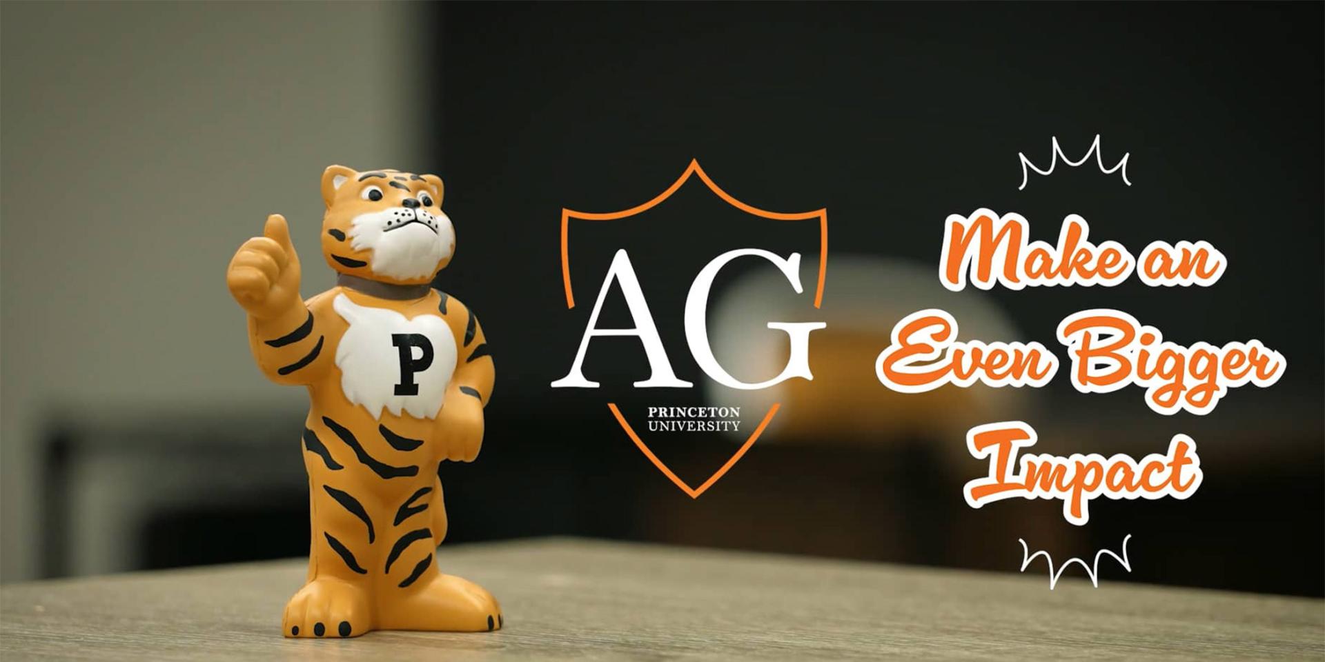 A toy Tiger stands on a desk, giving a thumbs-up gesture