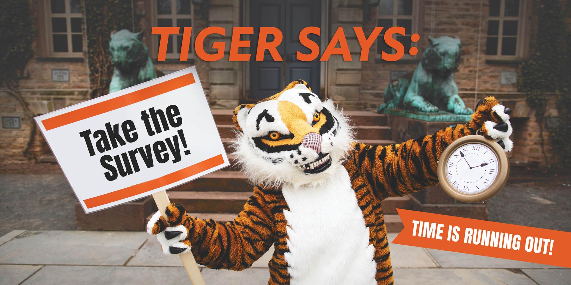 Tiger holds a sign encouraging alumni to take the new engagement survey