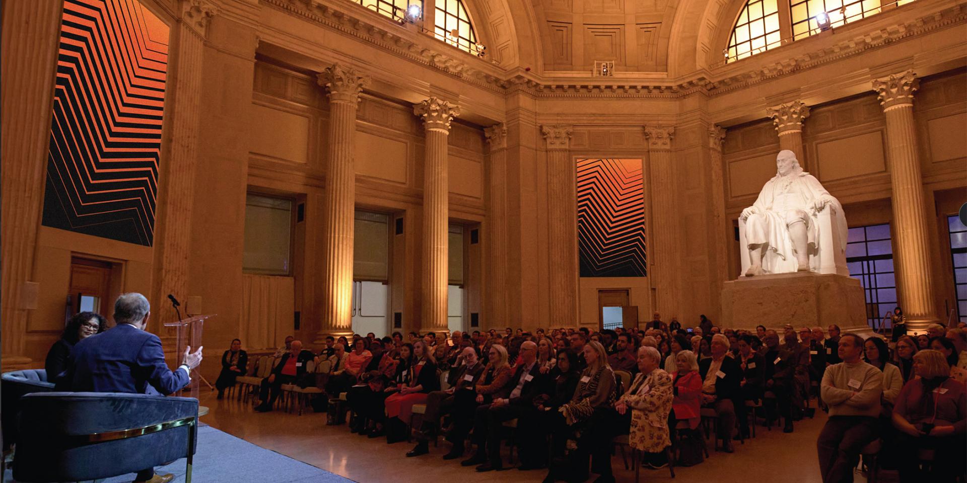 President Eisgruber sits on stage in front of an audience of Princeton alumni at the Franklin Institute in Phialdelphia. 