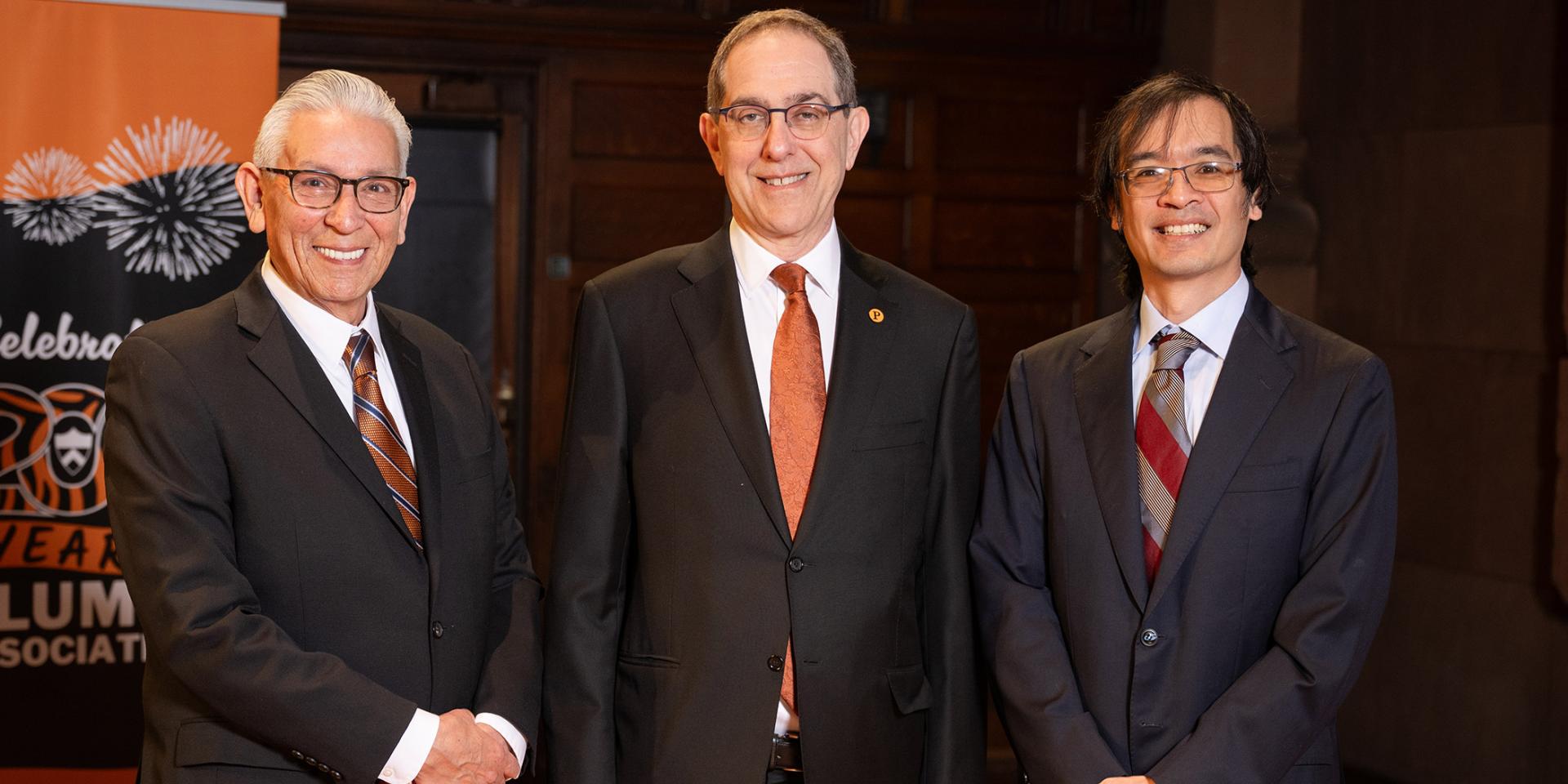Kevin Gover, President Eisgruber and Terence Tao standing side by side on the stage of Richardson Auditorium.