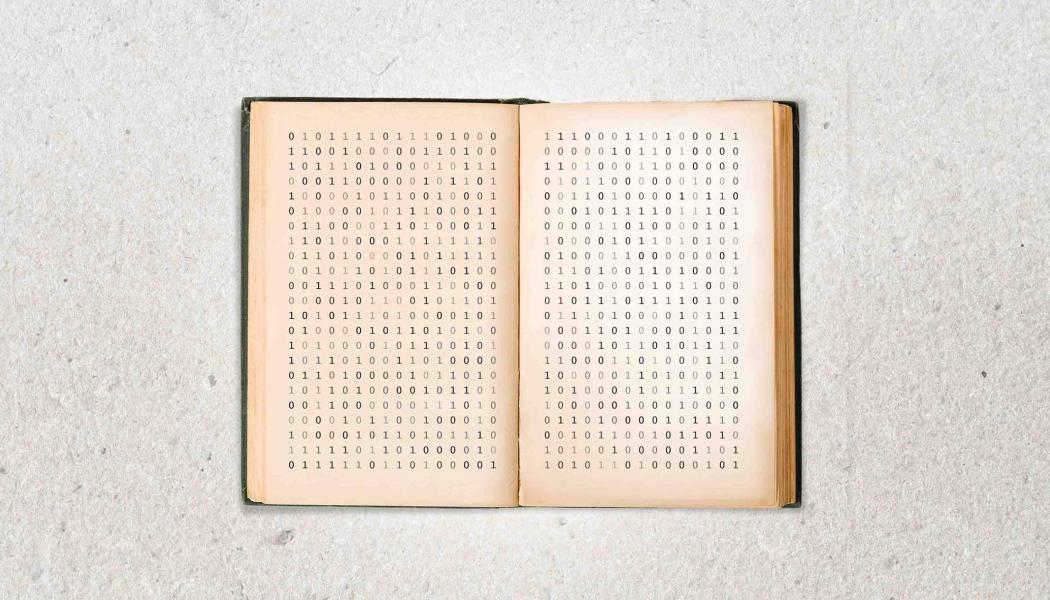 An open book with zeroes and ones printed on the page