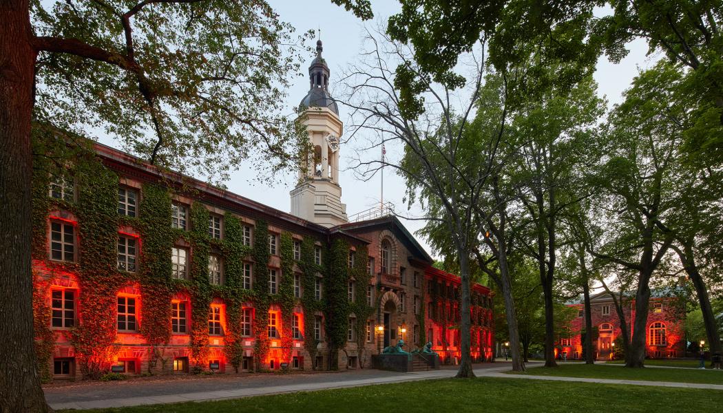 Nassau Hall, illuminated by orange lights