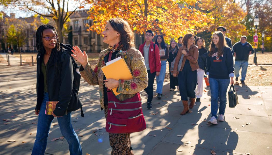 Students from the team-taught Humanities Sequence cross campus with course professors Esther “Starry” Schor (foreground) and Barbara Graziosi (in brown jacket).