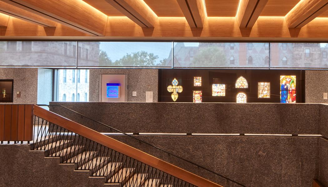 An interior of the Grand Stairs and oritnation gallery of the new Princeton University Art Museum, with campus showing through the glass