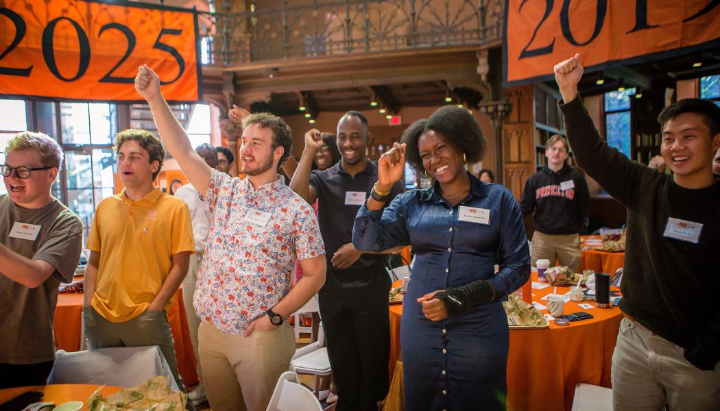 Recent alumni stand in a Locomotive cheer