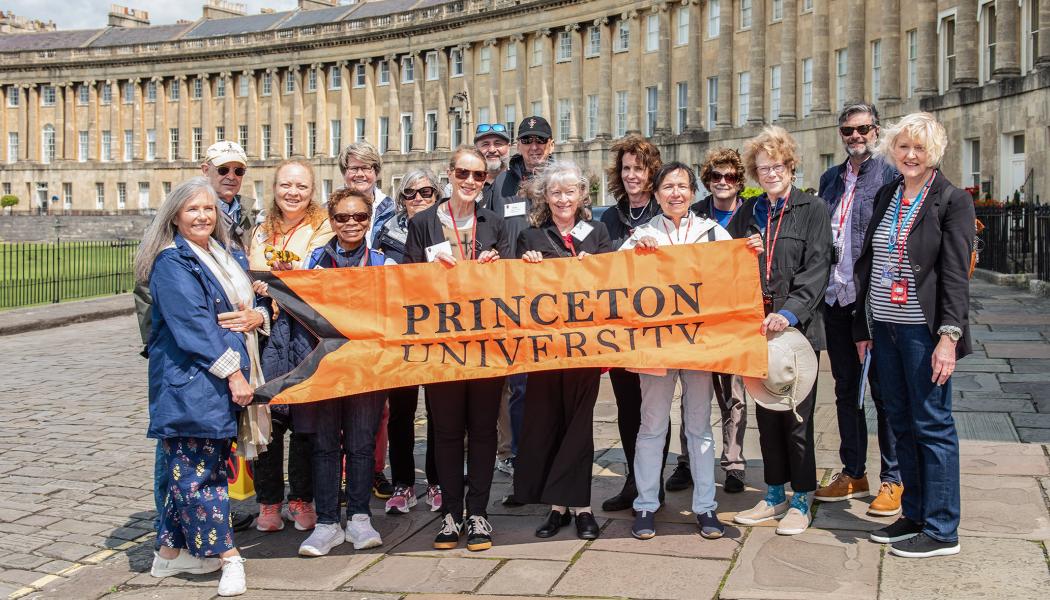 Princeton alumni and friends hold an orange Princeton banner in front of No. 1 Royal Crescent, part of the Jane Austen tour