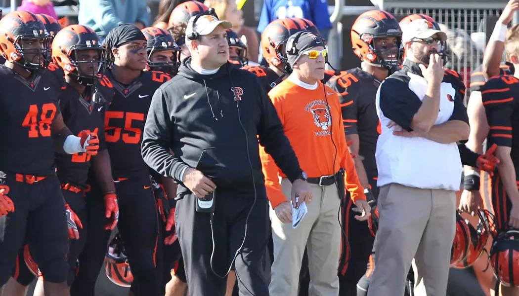 Head football coach Bob Surace and coaches and players on the Tigers sideline