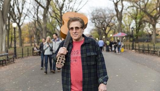 Joel Rosenman '63 with guitar