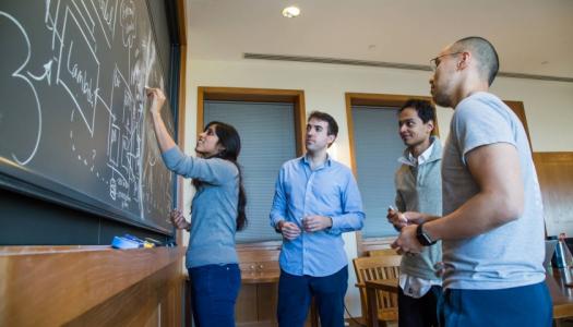 Graduate students at chalk board