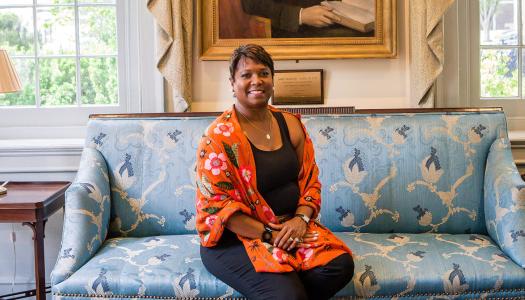Monica Moore Thompson sitting on the blue sofa in Maclean House