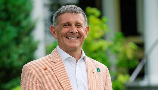 Ryan Ruskin, wearing his class jacket in front of Maclean House
