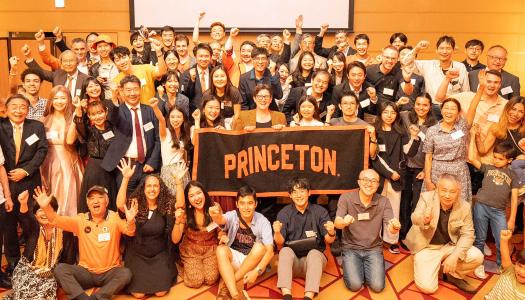 Jen Rexford and alumni from Japan hold a Princeton banner