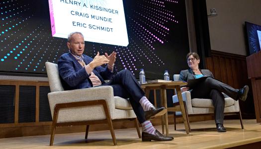 Eric Schmidt and Jen Rexford, seated on stage of McCosh 50