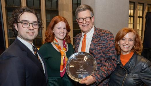 Jeff Sharp with his family as he holds the silver plated Helm Award