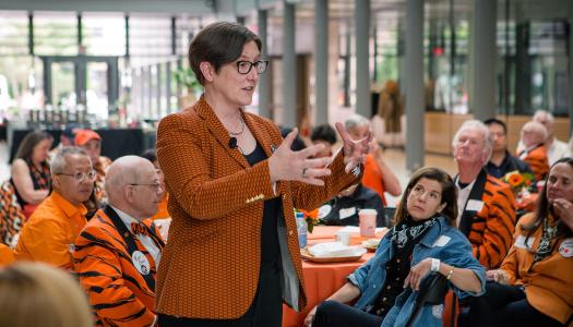 Provost Jennifer Rexford speaks to tables full of alumni