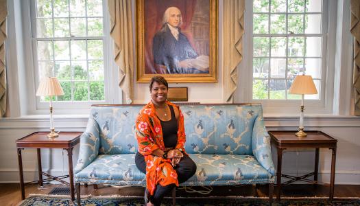 Monica Moore Thompson seated in front of James Madison portrait