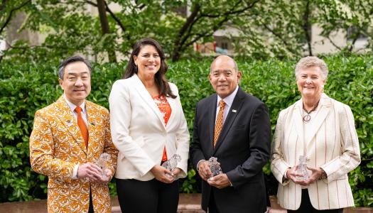 The four 2025 award winners with their crystal tigers
