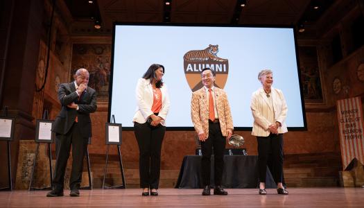 Four alumni on stage of Richardson Auditorium to accept their service awards