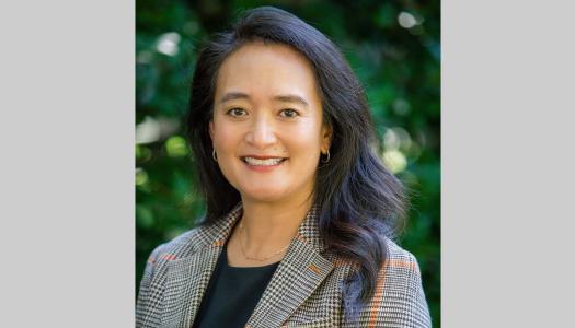 Portrait of April Chou with leafy green background