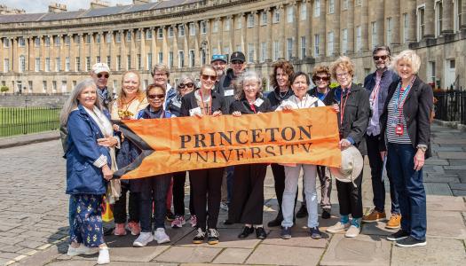 Princeton alumni and friends hold an orange Princeton banner in front of No. 1 Royal Crescent, part of the Jane Austen tour