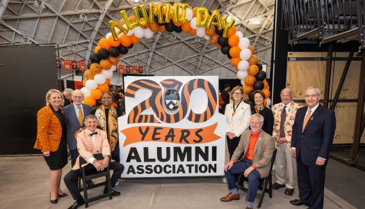 Ryan Ruskin and former chairs of the Alumni Council crowd around the form sculture celebrating the 200th anniversary of the Alumni Association.