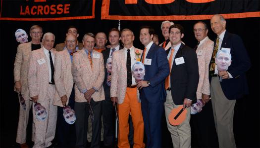Chase Bryce, surrounded by alumni holding cut-outs of his face