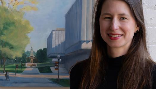 Headshot of Katherine Boyce with a painting behind her