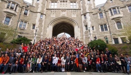 A group photo from the 2015 We Flourish conference with hundreds of Asian alumni on the steps of Blair Arch.