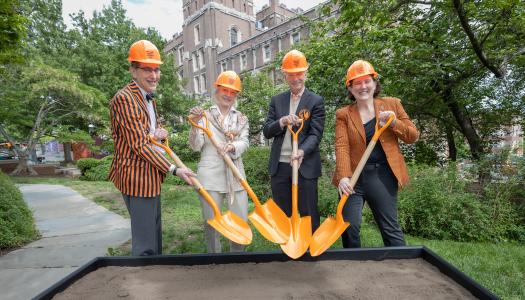 President Eisgruber, Wendy and Eric Schmidt, and Jen Rexford don orange hard hats and grab orange shovels for a ceremonial groundbreaking