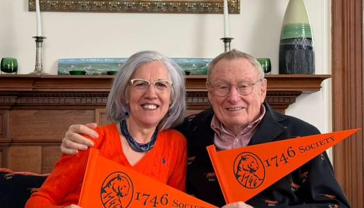 Ada and Tom Deuel hold 1746 Society pennants
