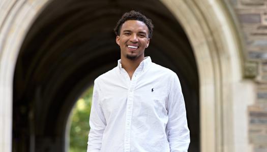 D'Schon Simmons smiling in front of Princeton campus arch.