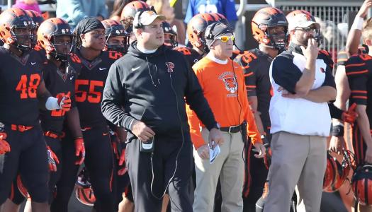 Head football coach Bob Surace and coaches and players on the Tigers sideline