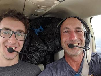 Asher and Todd Green '90 in the plane