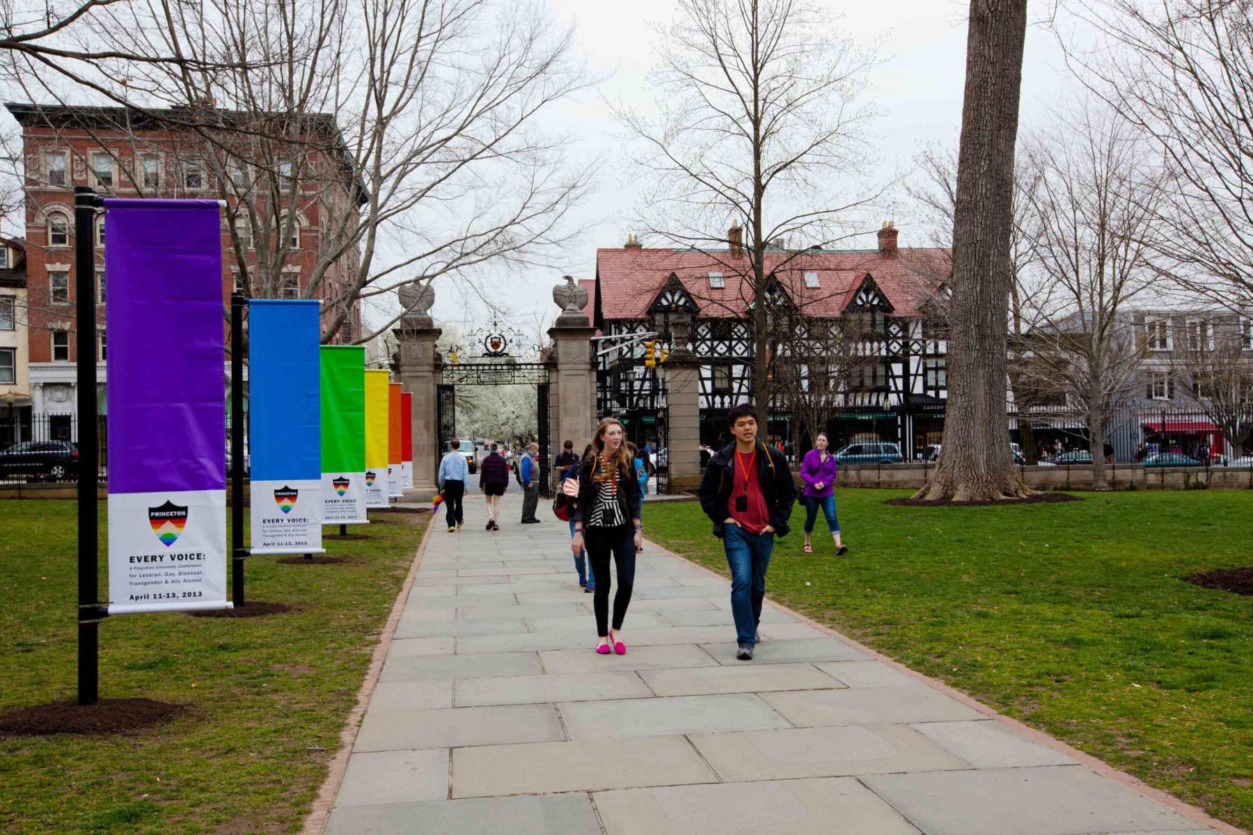 Students walking past rainbow flags