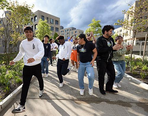 Kwanza Jones '93 and members of Old NasSoul lead guests to Jose E Feliciano Hall.