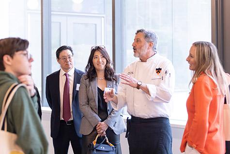 Natalie Shim Choi and her husband, Robert, listen to the chef in Choi Dining Hall 