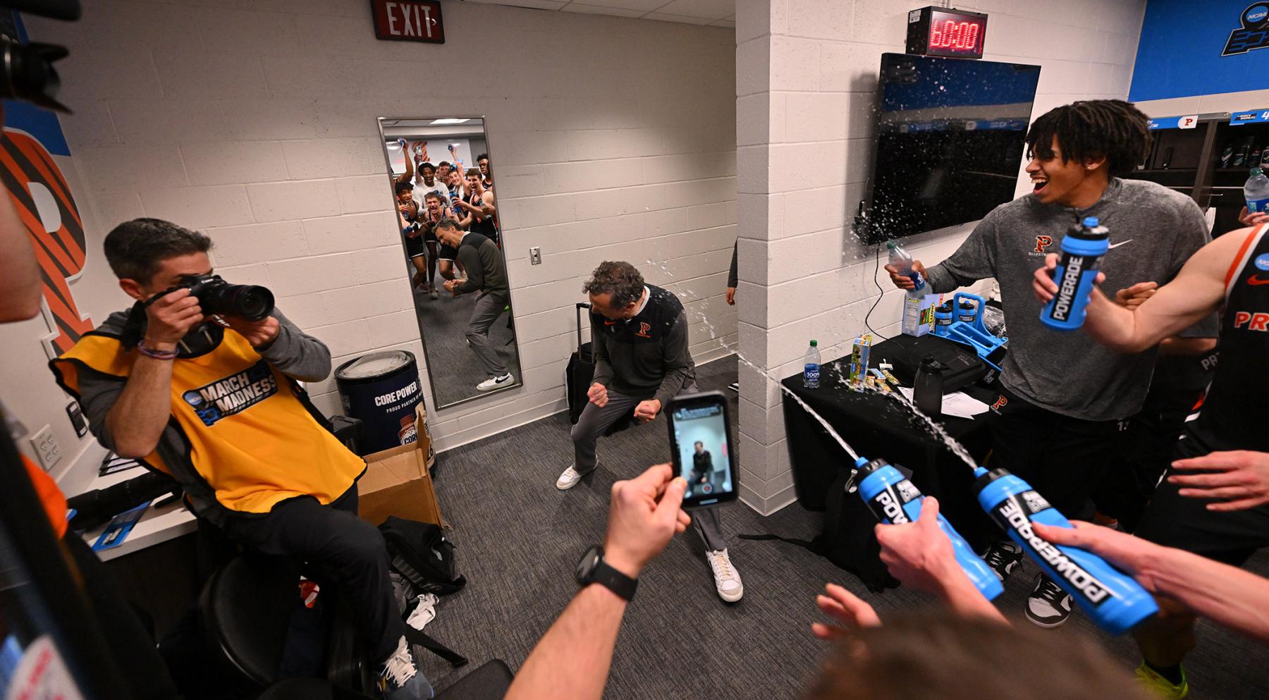 The men's basketball team douses Mitch Henderson with water after their upset victory against Arizona.