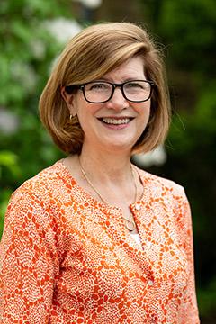 Heather Seagroatt wearing an orange dress