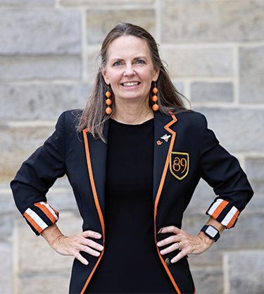 Alumna Susie Brennan in front of stone wall